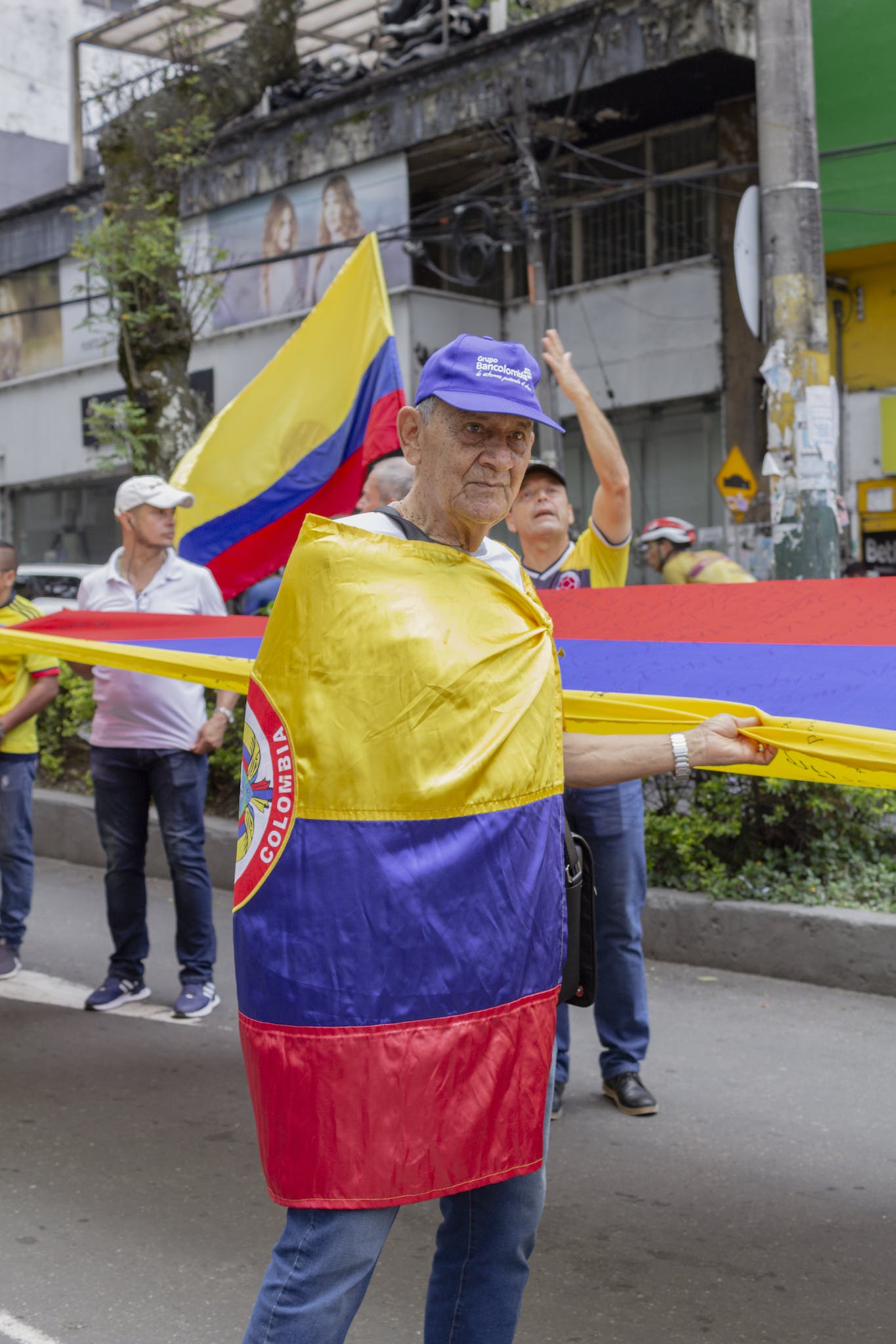 An Elderly Man Wrapped with a Colombian Flag
